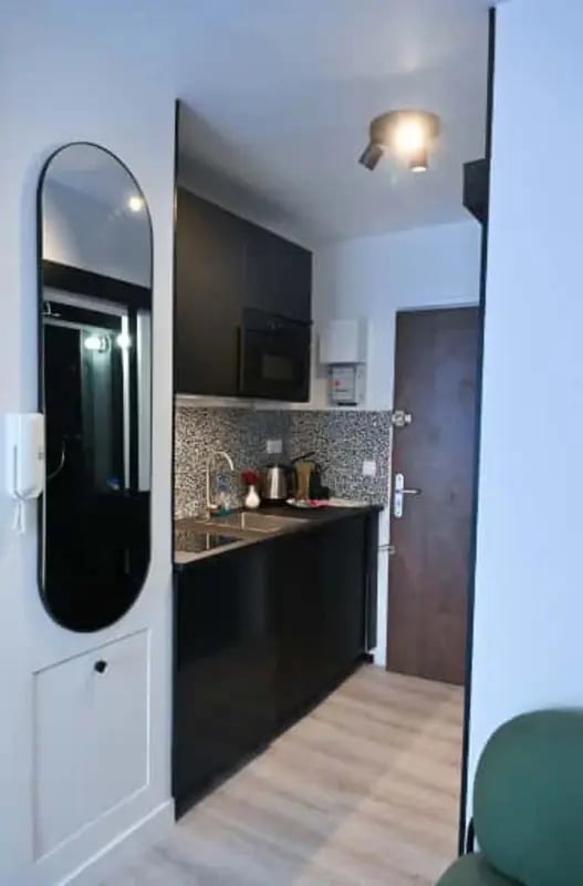 Black cabinets sink and mirror kitchen at Splendide grand studio parking Canal Saint Martin (Paris) in Paris Student Accommodation