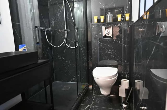 Modern black marble bathroom with walk-in shower bathroom at Splendide grand studio parking Canal Saint Martin (Paris) in Paris Student Accommodation