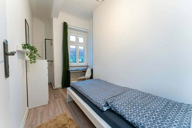 Bed whiteboard plant and closet bedroom at Sterndamm 75.2 75.3 in Berlin Student Accommodation