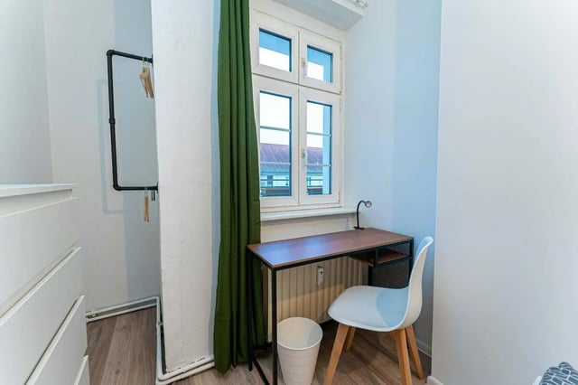 Desk chair lamp trash bin closet study area at Sterndamm 75.2 75.3 in Berlin Student Accommodation