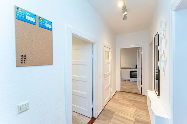 Corkboard with pins and rack near doors hallway interior at Sterndamm 75.2 75.3 in Berlin Student Accommodation