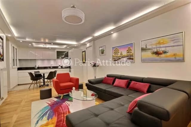 Lounge with sofa table chairs paintings kitchen area living room at Apartment in Rue de Clichy, 75009 Paris, France in Paris Student Accommodation