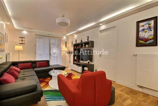 Sectional sofa with red cushions and chair living room at Apartment in Rue de Clichy, 75009 Paris, France in Paris Student Accommodation
