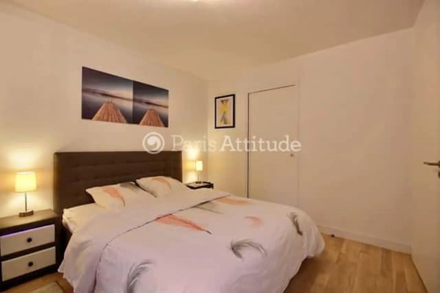 Bed with lamps and artwork bedroom at Apartment in Rue de Clichy, 75009 Paris, France in Paris Student Accommodation