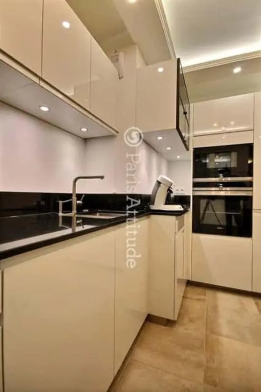 Modern kitchen with white cabinets oven and sink kitchen at Apartment in Rue de Clichy, 75009 Paris, France in Paris Student Accommodation