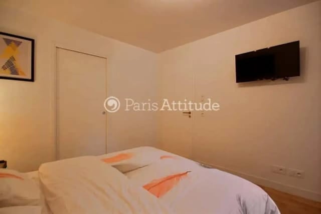 Bed with TV and artwork Bedroom at Apartment in Rue de Clichy, 75009 Paris, France in Paris Student Accommodation