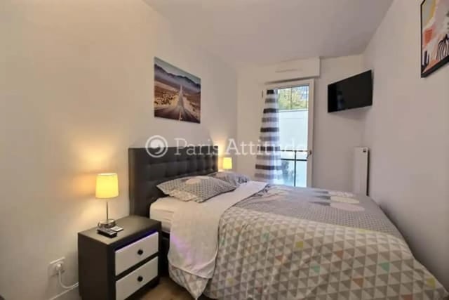 Bed nightstand lamp painting television bedroom at Apartment in Rue de Clichy, 75009 Paris, France in Paris Student Accommodation