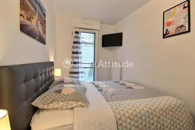 Tufted headboard patterned bedding and artwork bedroom at Apartment in Rue de Clichy, 75009 Paris, France in Paris Student Accommodation