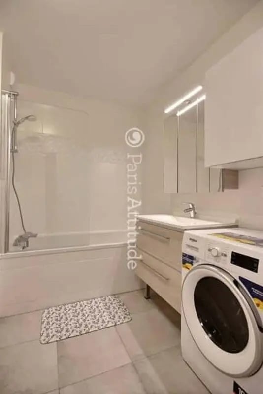 Bathtub shower sink washing machine bathroom at Apartment in Rue de Clichy, 75009 Paris, France in Paris Student Accommodation