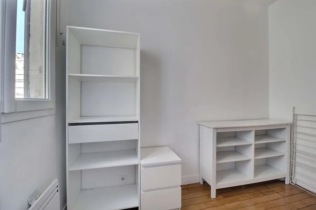 White shelving unit and dresser study area at Apartment in Rue Etienne Jodelle, 75018 Paris, France in Paris Student Accommodation