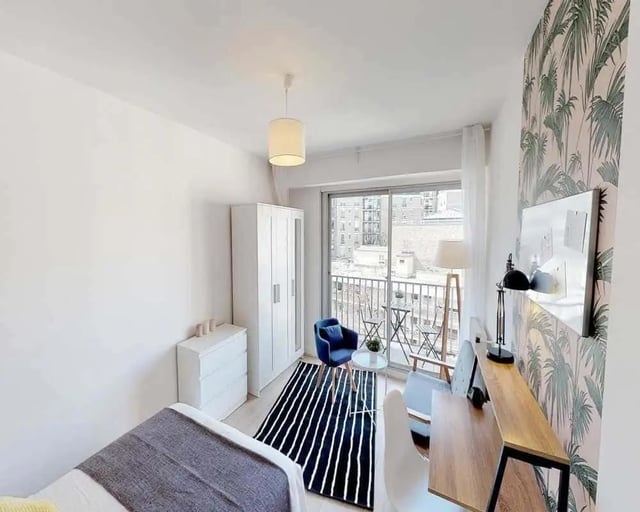 Bedroom with wardrobe desk chair and balcony living room at Chambre dans le rue d'Hautpoul in Paris Student Accommodation
