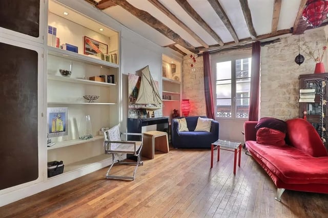 Red chaise sofa blue sofa chairs bookshelf living room at Apartment 2 bedrooms 63m² in Paris Student Accommodation