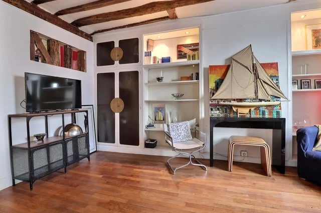 TV shelf chair bookshelf sailboat living room at Apartment 2 bedrooms 63m² in Paris Student Accommodation