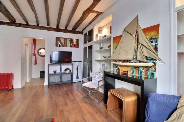 Model ship on shelf with colorful artwork living room at Apartment 2 bedrooms 63m² in Paris Student Accommodation