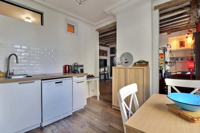 White cabinets sink dishwasher red kettle kitchen at Apartment 2 bedrooms 63m² in Paris Student Accommodation