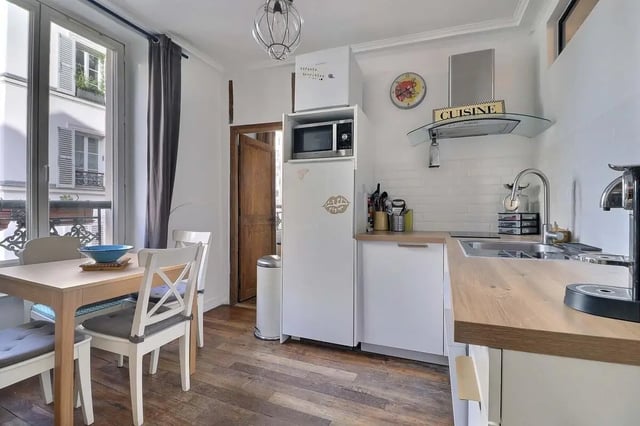 Dining table chairs refrigerator microwave kitchen kitchen at Apartment 2 bedrooms 63m² in Paris Student Accommodation