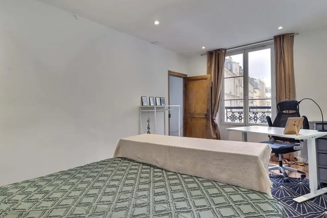 Bed desk chair window overlooking buildings bedroom at Apartment 2 bedrooms 63m² in Paris Student Accommodation