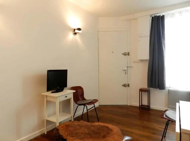 Television table chair and door living room at Apartment 1 bedroom 28m² in Paris Student Accommodation