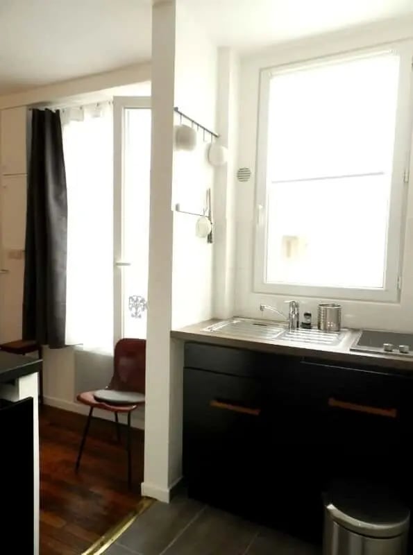 Sink faucet brown chair window kitchen at Apartment 1 bedroom 28m² in Paris Student Accommodation