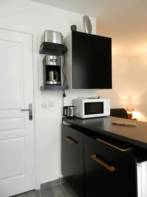 Toaster coffee maker microwave black cabinets kitchen at Apartment 1 bedroom 28m² in Paris Student Accommodation