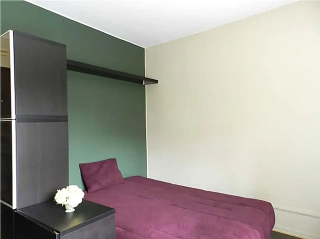 Dark wardrobe purple bed flowers bedroom at Studio in Rue Mademoiselle, 75015 Paris, France in Paris Student Accommodation