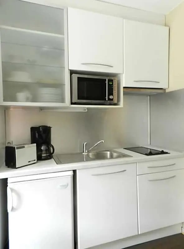 White cabinets microwave toaster coffee maker sink kitchen at Studio in Rue Mademoiselle, 75015 Paris, France in Paris Student Accommodation