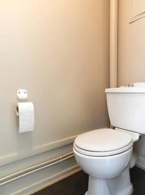 White toilet and toilet paper holder bathroom at Studio in Rue Mademoiselle, 75015 Paris, France in Paris Student Accommodation