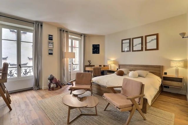 Bed desk chairs rug and art Bedroom at Apartment Studio 38m² in Paris Student Accommodation