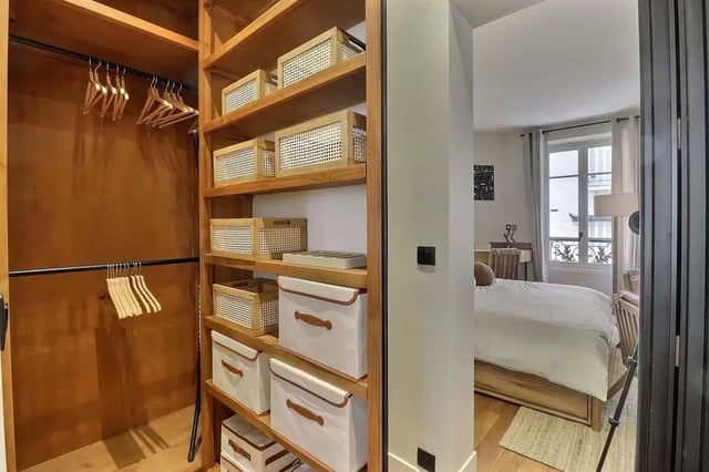 Wardrobe with baskets and bed in bedroom at Apartment Studio 38m² in Paris Student Accommodation