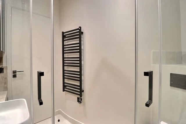 Black towel rack sink and shower doors bathroom at Apartment Studio 38m² in Paris Student Accommodation