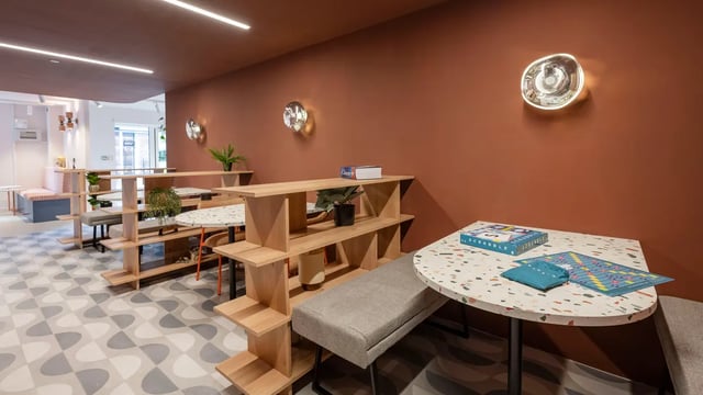 Terracotta wall Scrabble table with benches communal area at Selly Oak Court in Birmingham Student Accommodation