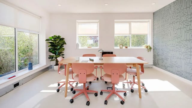 Wooden table and pink chairs study area at Selly Oak Court in Birmingham Student Accommodation