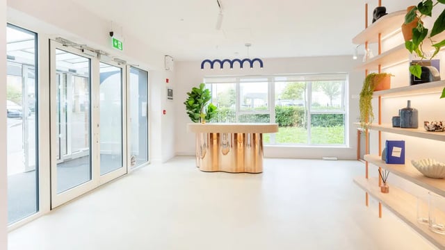Glass doors reception desk plant shelves lobby at Selly Oak Court in Birmingham Student Accommodation