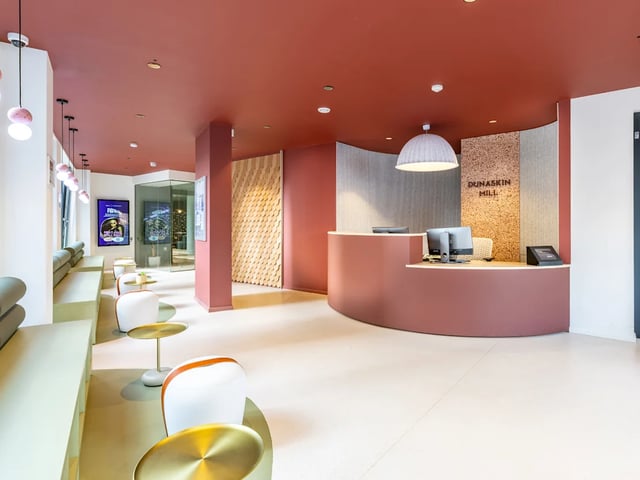 Reception desk with computers and seating area lobby at Dunaskin Mill in Glasgow Student Accommodation