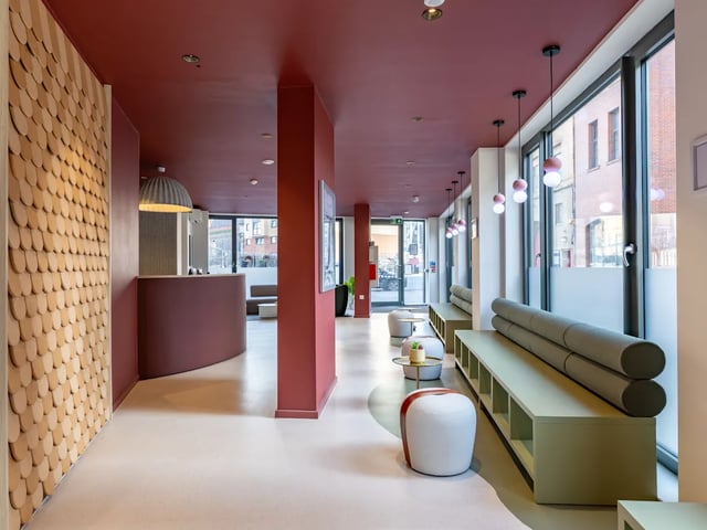 Reception desk bench seating and stools lobby at Dunaskin Mill in Glasgow Student Accommodation