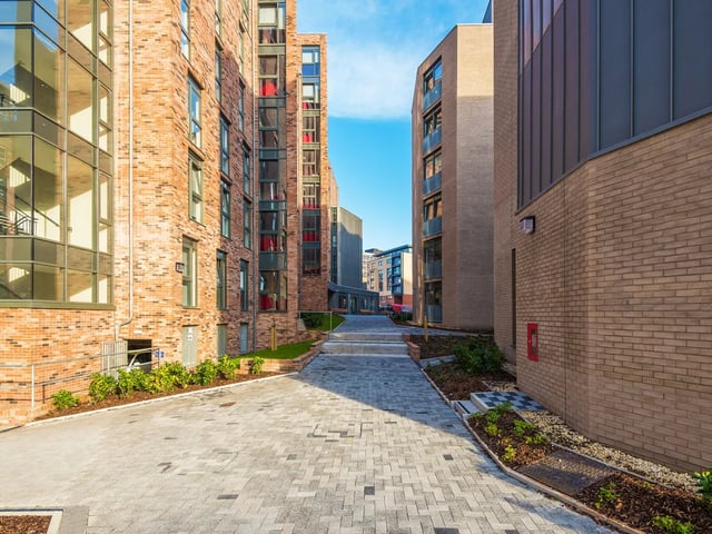 Brick buildings with pathways and landscaping exterior at Dunaskin Mill in Glasgow Student Accommodation