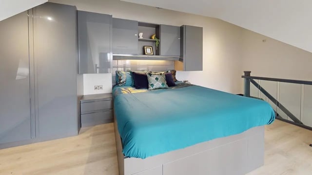 Bed with teal duvet grey cabinets white wall Bedroom at The Residence in Coventry Student Accommodation