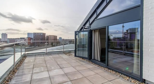 Tiled balcony with glass railing cityscape view exterior at The Residence in Coventry Student Accommodation