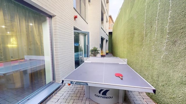 Ping pong table with paddle in courtyard playing area at The Residence in Coventry Student Accommodation