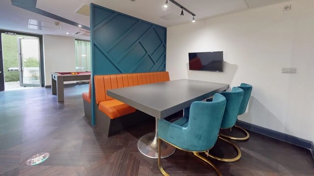 Table chairs booth TV pool table lounge area at The Residence in Coventry Student Accommodation