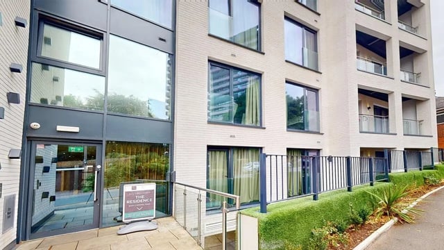 Building entrance with signs and balcony exterior at The Residence in Coventry Student Accommodation