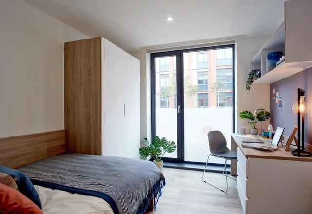 Bed wardrobe desk chair window bedroom at Eden Square in Coventry Student Accommodation