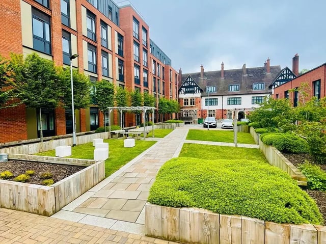 Courtyard with brick buildings white benches exterior at Eden Square in Coventry Student Accommodation