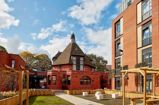 Brick buildings with wooden seating area exterior at Eden Square in Coventry Student Accommodation