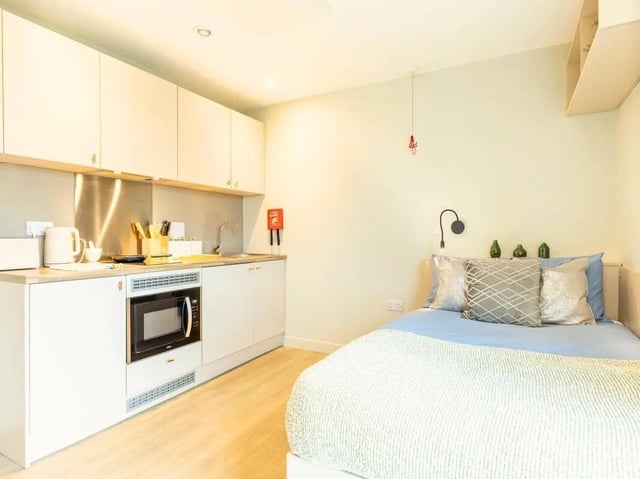 Kitchenette with microwave bed with pillows studio apartment at Straits Meadow in Edinburgh Student Accommodation