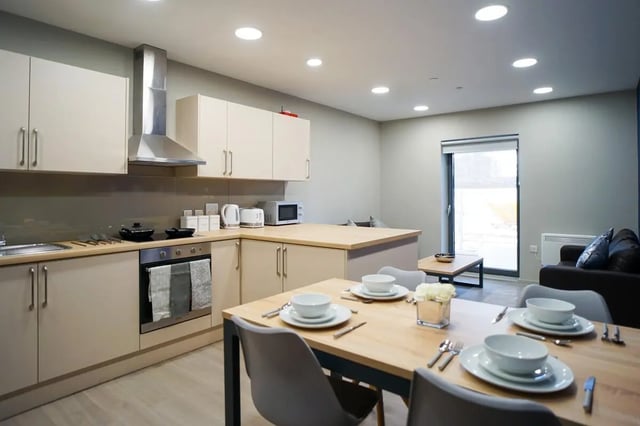 Kitchen dining area with table chairs and sofa Living room at Straits Meadow in Edinburgh Student Accommodation