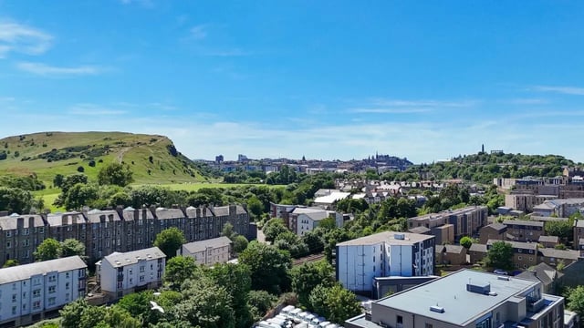 Apartment buildings surrounded by trees with city skyline exterior at Straits Meadow in Edinburgh Student Accommodation