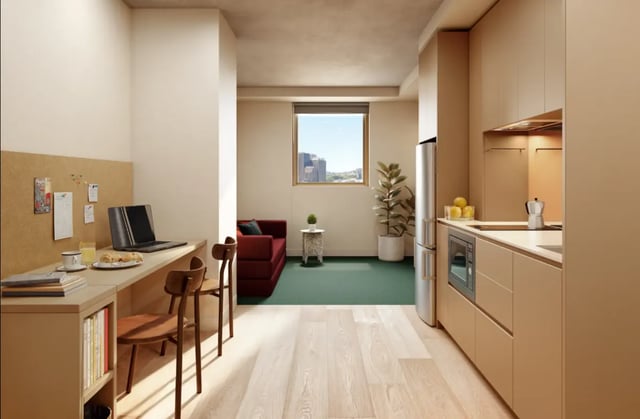 Desk laptop couch kitchen living room interior at The Switch Berkeley in Melbourne Student Accommodation