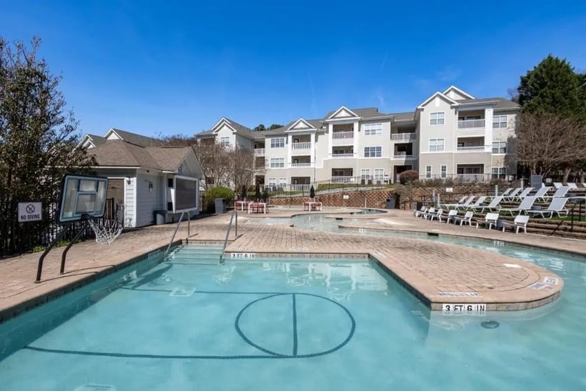 Pool area with basketball hoop and lounge chairs exterior at Campus Edge Apartments in Raleigh Student Accommodation