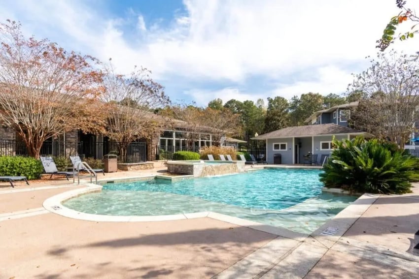 Pool and jacuzzi with lounge chairs exterior at The Mill at Auburn in Auburn Student Accommodation